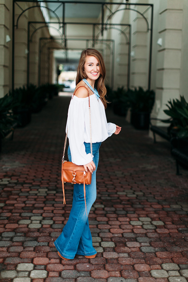 bell bottom jeans, tassel crossbody, off the shoulder long sleeved top, akola project collar, seventies style, southern girl style, lace up platforms